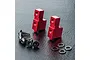 Two red anodized aluminium servo mounts with a set of black screws and washers on a textured black surface.