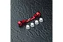 MST red aluminium suspension arm mount with +3.5/+5 markings and four small white plastic inserts on a dark textured surface.
