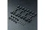 A set of black MST adjustable shock end parts including plastic trees, spacers, and O-rings on a textured black surface.
