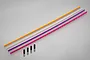 Four long, thin antenna tubes in orange, clear, purple, and pink, accompanied by four small black rubber antenna caps on a grey background.