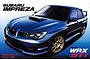 Box art for a Fujimi 1/24 scale Subaru Impreza WRX STI model kit featuring a blue sedan with gold wheels.