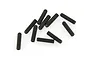 A collection of ten black metal grub screws with fine threading scattered on a white background.