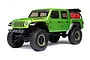 A studio shot of the Axial SCX24 Jeep Gladiator RC rock crawler in green, featuring black wheels with green trim and a red accessory mounted in the truck bed.