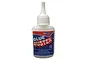 A 28g bottle of Deluxe Materials Glue Buster adhesive remover with a white cap and blue and red label.
