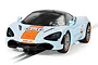 A Scalextric 1/32 scale McLaren 720S slot car in the iconic Gulf blue and orange livery, shown on a track section.