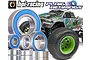 A selection of metal ball bearings with blue rubber seals arranged in front of an HPI Savage Flux XS RC monster truck.