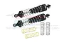 Two black GPM Racing aluminium RC shock absorbers with extra gold and black springs on a white background.
