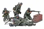 A set of five painted 1/35 scale Tamiya German military figures, including a machine gun team with an MG42, set against a white background.