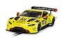 A Scalextric 1/32 scale Aston Martin GT3 Vantage slot car in bright yellow with Penny Homes Racing livery on a track section.