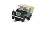 A Scalextric 1/32 scale Land Rover Series 1 slot car in dark green with a tan soft top, positioned on a slot car track.