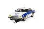 A 1/32 scale Scalextric Jaguar XJS slot car, number 10, featuring Citibank livery on a white and blue body, positioned on a slot car track.