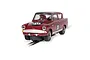 A 1/32 scale Scalextric Ford Anglia 105E slot car in maroon with racing number 30, positioned on a slot car track against a white background.