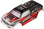 A pre-painted red, black, and silver RC truck body shell with Spirit branding, viewed from a high angle against a white background.