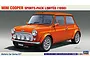 Box art illustration of a bright orange 1998 Mini Cooper Sports Pack Limited model car on a grey background.