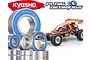 A collection of metal ball bearings with blue rubber seals displayed in front of a Kyosho Javelin RC buggy.