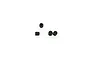 Four small black metal grub screws arranged on a white background.