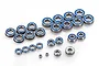 A collection of various sized metal ball bearings with blue rubber seals arranged on a white background.