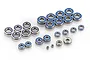 A collection of various sized metal ball bearings with blue rubber seals arranged on a white background.