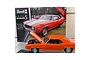 A 1/12 scale Revell model of a bright orange 1969 Chevrolet Camaro with its hood open, displayed in front of its product box.