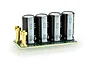 Castle Creations 8S capacitor pack featuring four black electrolytic capacitors mounted on a green circuit board with gold-plated terminals.