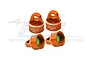 Four orange anodized aluminium RC shock caps from GPM Racing, featuring 7075 branding and internal green seals, arranged on a white background.