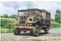 A detailed illustration of a military Chevrolet 15 CWT truck parked on a rural road, featuring camouflage paint and D-Day markings.