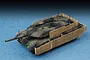 A high-angle studio shot of a 1/72 scale Leopard 2A6M CAN tank model, featuring a camouflage paint scheme and tan slat armor cages.
