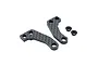 Two carbon fibre RC steering hub plates and two small black metal spacers on a white background.