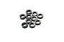 A cluster of ten small black cylindrical aluminium shims or spacers for RC car maintenance.