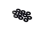A collection of ten small, thin, black circular shims or washers arranged on a white background.