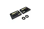 Two black RC Maker brass front weights with gold branding and two small carbon fiber washers on a white background.