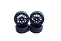 Four black 1/10 scale RC touring car radial tyres mounted on black multi-spoke rims, arranged in a stack against a white background.