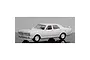 A white, unpainted 1/24 scale model kit of a Ford GTHO XY sedan on a reflective surface.